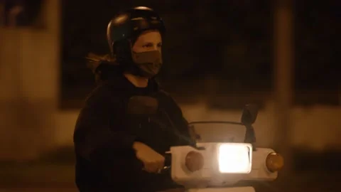 Boy driving a scooter at night 스톡 동영상 160296416