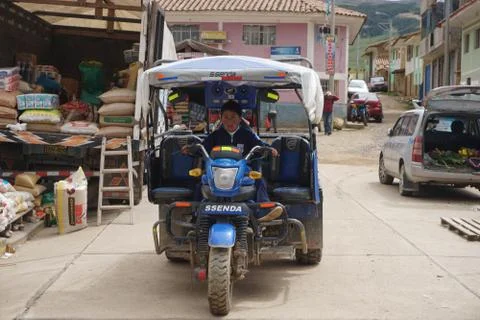 Boy driving tuk tuk in rural Peru Stock Photos