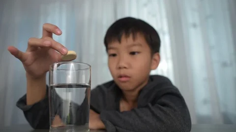 Boy drop table soda to make a bubble water Stock Footage 114307352