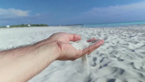 A boy drops white sand from his hand Stock Footage 250186818