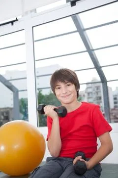 Boy with dumbbells Stock Photos