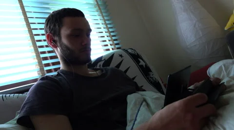 Boy with Earphones Using Tablet in Bedroom, Blinds Backlightrg (6) Stock-Footage 67637077