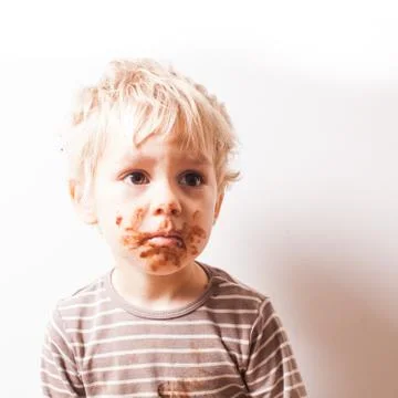 Boy eated chocolate Stock Photos