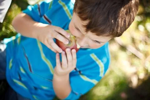 Boy eating an apple Foto stock