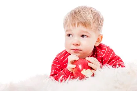Boy eating apple Stock Photos