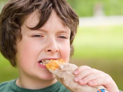 Boy eating bread Foto stock