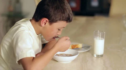 Boy eating breakfast Stock Footage 23163000