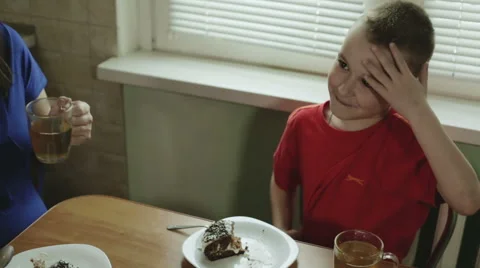 The boy is eating cake and showing gestures, that the cake is very tasty. Stock Footage 63204644