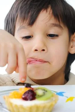 Boy eating cake Stock Photos
