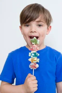 Boy eating candies Stock Photos