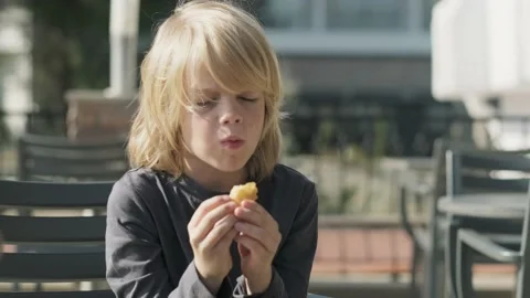 boy eating chicken nuggets in fast food ... | Stock Video | Pond5