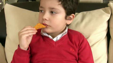 Boy eating chips 3 Stock Footage 34318164