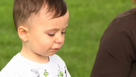 The boy is eating corn in nature Stock Footage 111747597