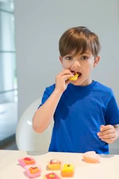 Boy eating a cup cake Stock Photos