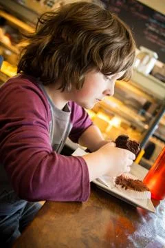 Boy eating a cupcake Stock Photos