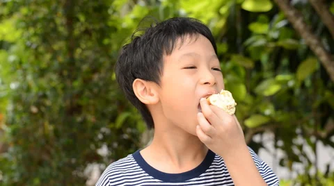 Boy eating donut Stock Footage 51717539