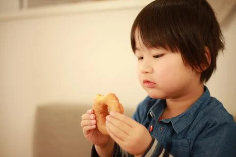 Boy eating donuts ​ Stock Photos