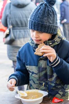Boy eating hot soup Stock Photos