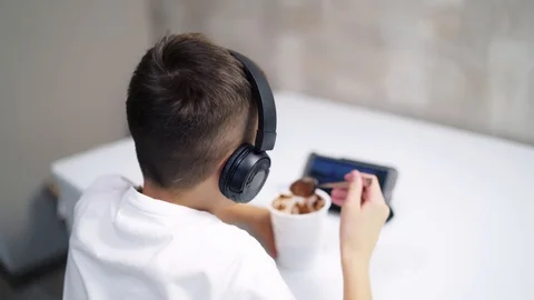 Boy eating in kitchen Stock Footage 123409099