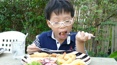 Boy eating lunch in restaurant Stock Footage 62209160