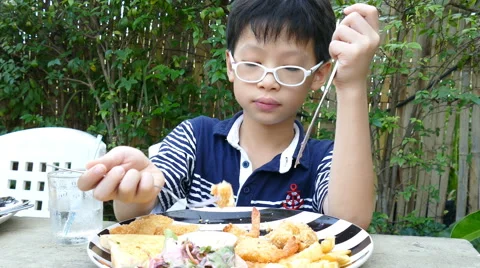 Boy eating lunch in restaurant Stock Footage 62209811