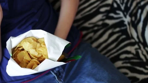 Boy Eating Packet Of Potato Chips unhealthy food Stock Footage