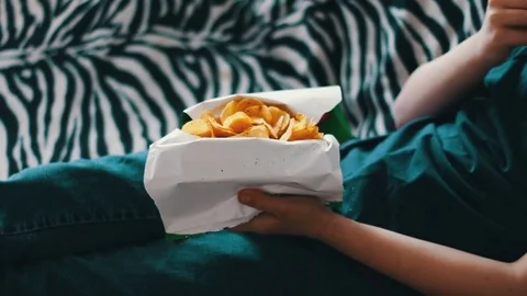 Boy Eating Packet Of Potato Chips unhealthy food Stock Footage 74271200