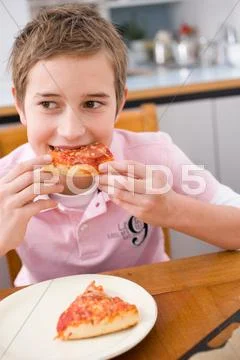 Boy Eating A Piece Of Pizza