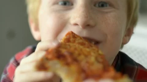 Boy eating pizza Stock Footage