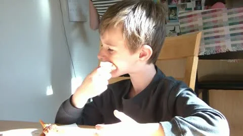 Boy Eating Sandwich at Table Video stock 12571635