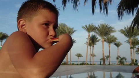 Boy eating a slice of pizza Video stock 127656491