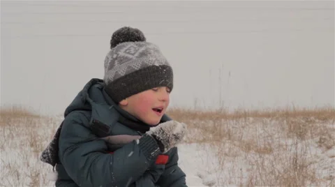 Boy eating snow Video stock 64797948