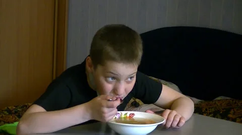 Boy eating soup Stock Footage 62475414