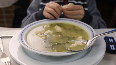 Boy eating soup in restaurant Video stock 103149798