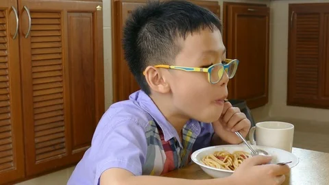 Boy eating spaghetti Stock Footage 71756199