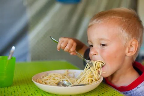 Boy eating spaghetti. Stock Photos