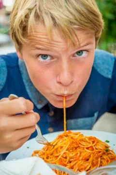 Boy eating spaghetti Stock Photos