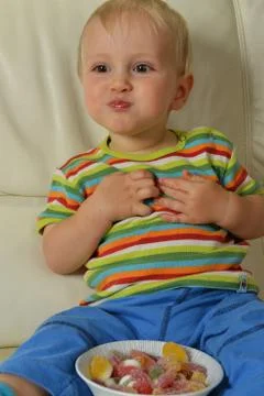 Boy eating sweets Stock Photos