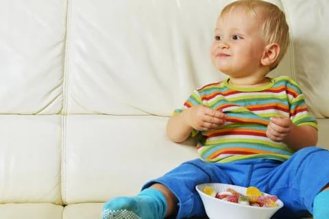 Boy eating sweets Stock Photos