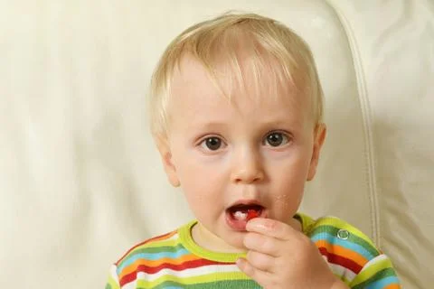Boy eating sweets Stock Photos