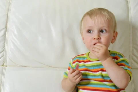 Boy eating sweets Stock Photos