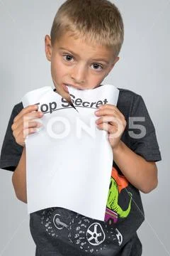 Boy Eating Top Secret Document Stock Photos