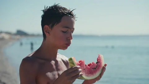 Boy eating watermelon on the beach, summertime 스톡 동영상 200657060