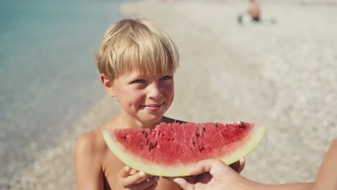 Boy eating watermelon on the beach, summertime 스톡 동영상 200783109