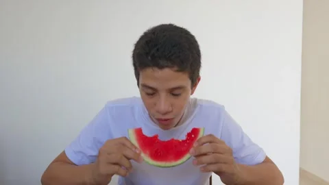 A boy is eating a watermelon slice Stock Footage 310186950