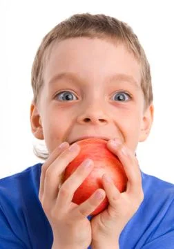 Boy eats an apple Stock Photos