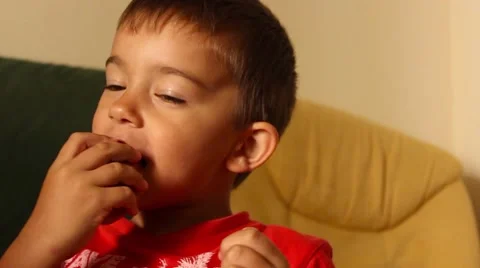 Boy eats apple with unclean mouth Stock Footage 65300370