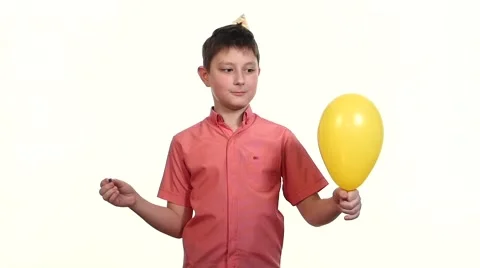 Boy eats balloon with a needle and frightening explosion slow motion Stock Footage 48535003