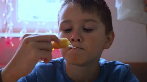 A boy eats cheese sticks in a cafe. the cheese stretches. fast food. junk food Stock Footage 166738630