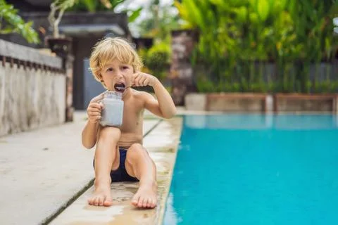 The boy eats chia pudding in the morning by the pool. Healthy breakfast. Useful Stock Photos